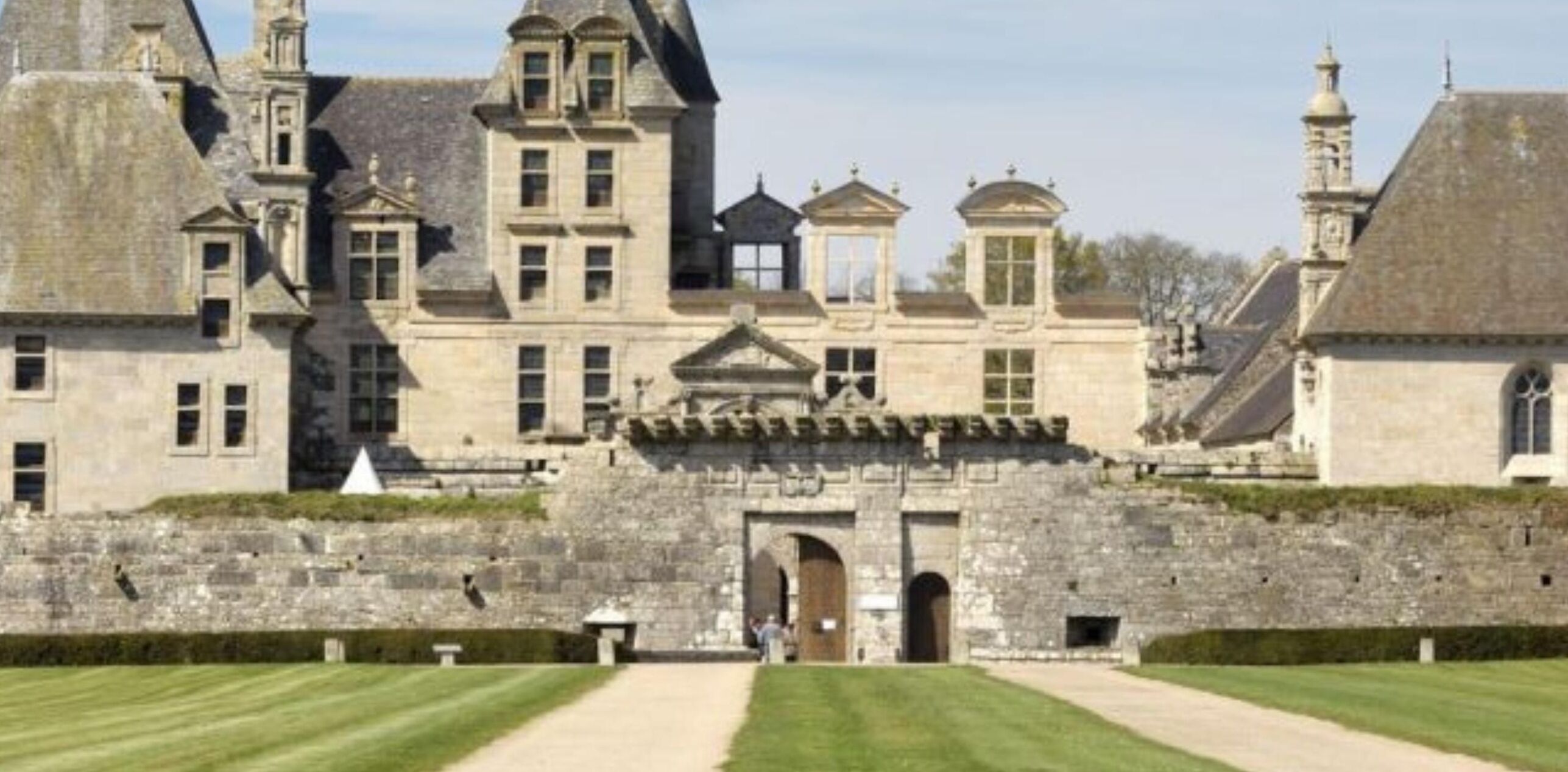 A historic building with a symmetrical facade, large windows, and a central entrance.