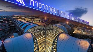 A modern airport terminal with a prominent illuminated sign, large covered waiting areas, and a bridge structure. - Room-thailand Taxi&apartment Hostel (Pak Kret)
