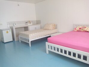 A bedroom with a bed, a small desk, and a nightstand. - Room-thailand Taxi&apartment Hostel (Pak Kret)