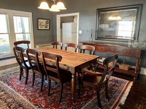 Large dining room with seating for eight and a long buffet table