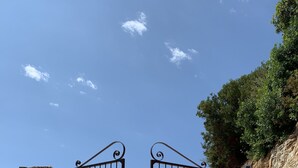Una entrada cerrada con muros de piedra y cielo despejado.