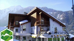 A two-story building with a ski lift in the background. - Pepi's vacation apartments including summer card with   17 services (Jerzens)