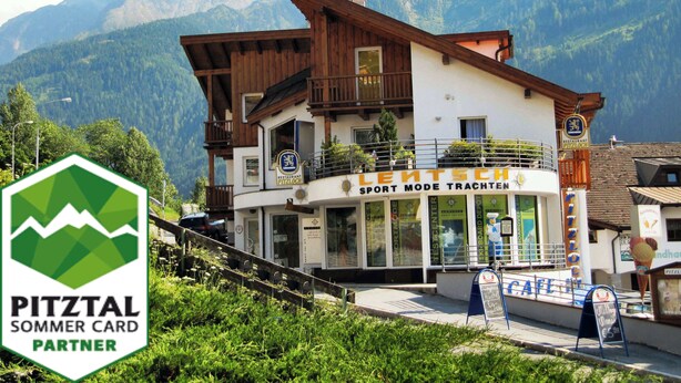 A building with a sign reading "Sport Mode Trachten" and "Restaurant Pitzlhaus" in front of a mountainous backdrop. - Pepi's vacation apartments including summer card with   17 services (Jerzens)