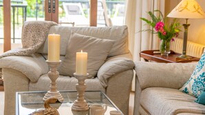 A cozy living room with a sofa, two candles on a glass table, and a lamp. - CA NA ROSA (DE SELVA) - Apartment with private pool and garden near the mountains. Free Wi (Selva)