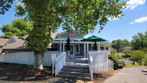 A building with a porch, steps, and a sign prohibiting pets on the deck. - Kingsmill Condo on Golf Course 9th Fairway! Local owner (Williamsburg)