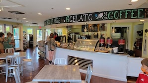 A gelato and coffee shop interior with a counter, seating area, and various food displays. - Kingsmill Condo on Golf Course 9th Fairway! Local owner (Williamsburg)