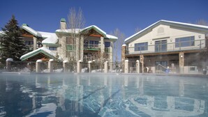 A hotel with a swimming pool, a covered area, and a building with a green roof. - CA117 | Lovely Mountainside Condo | Steps from slopes | Winter Shuttle | Hot Tub (Steamboat Springs)