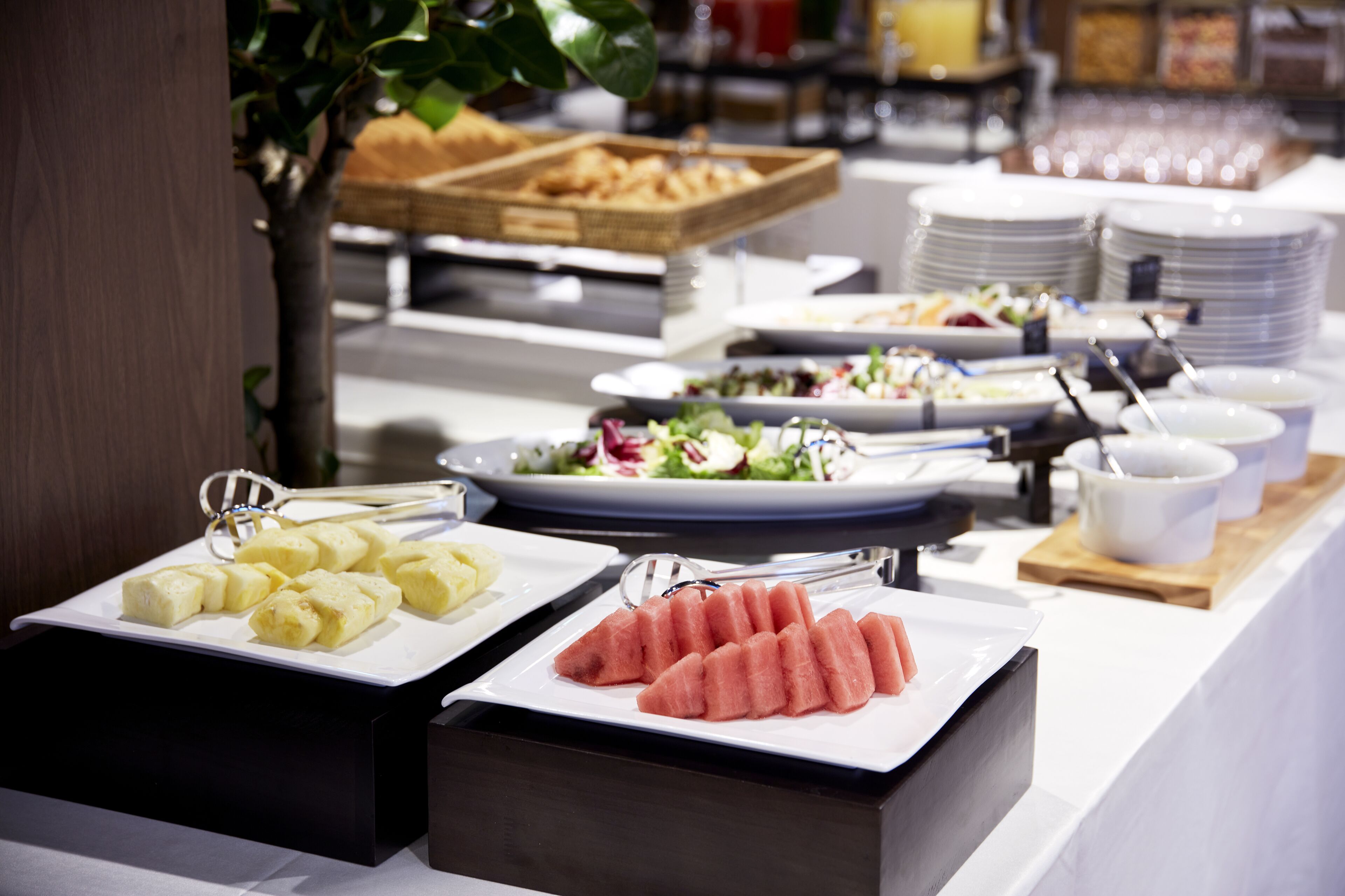 A buffet with various food items including fruits and salads.