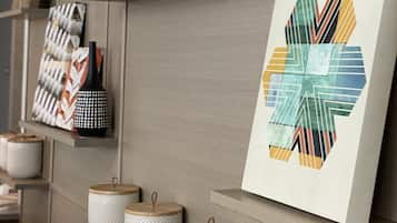 A modern interior with shelves displaying decorative items and a framed artwork.
