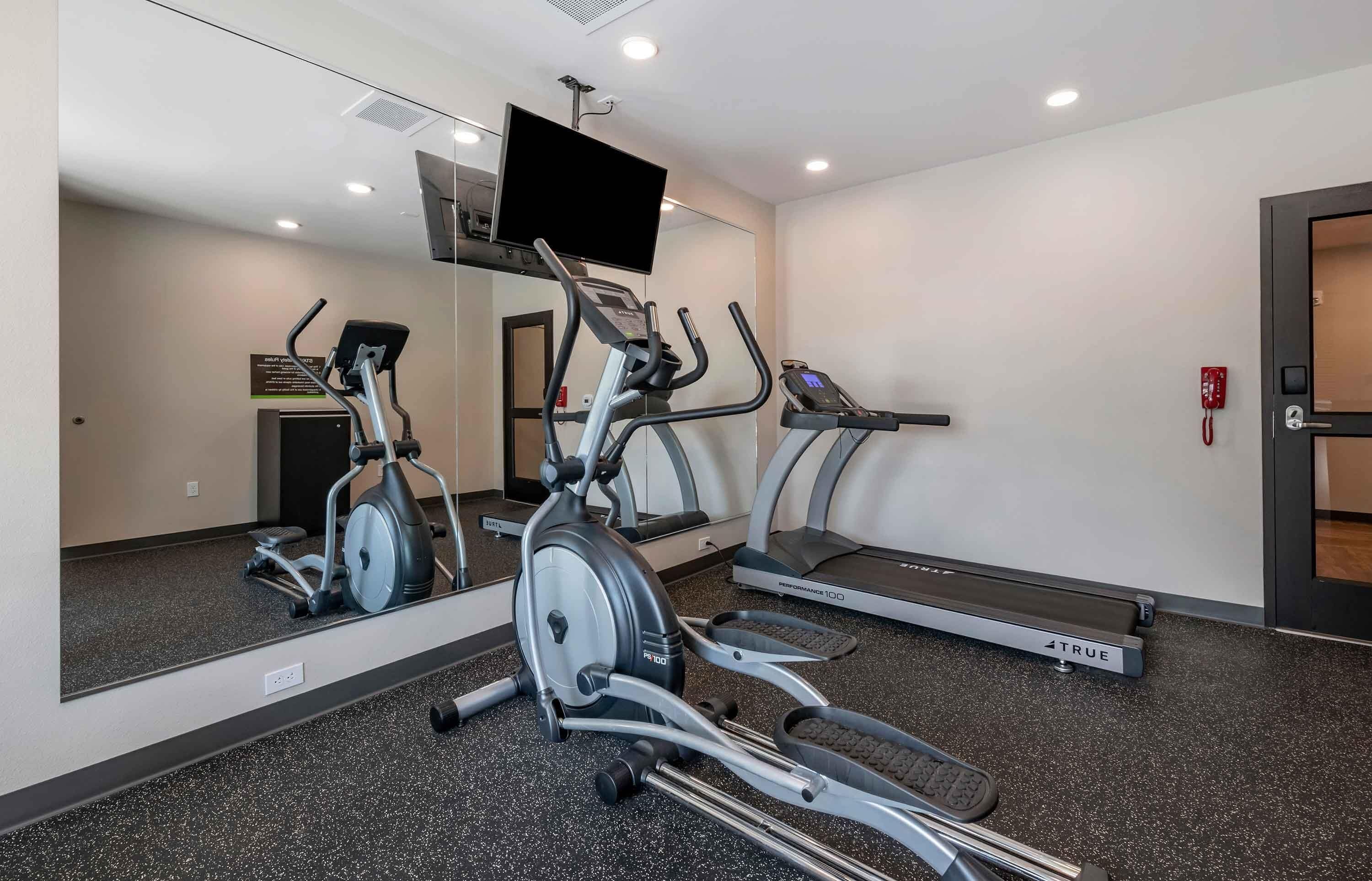A gym with stationary bikes, an elliptical, and treadmills.