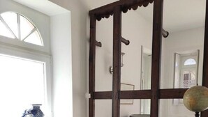 A compact kitchen with a window, a sink, a stove, and a wooden counter. - Gîte Rohan - Château du Parc Soubise (Mouchamps)