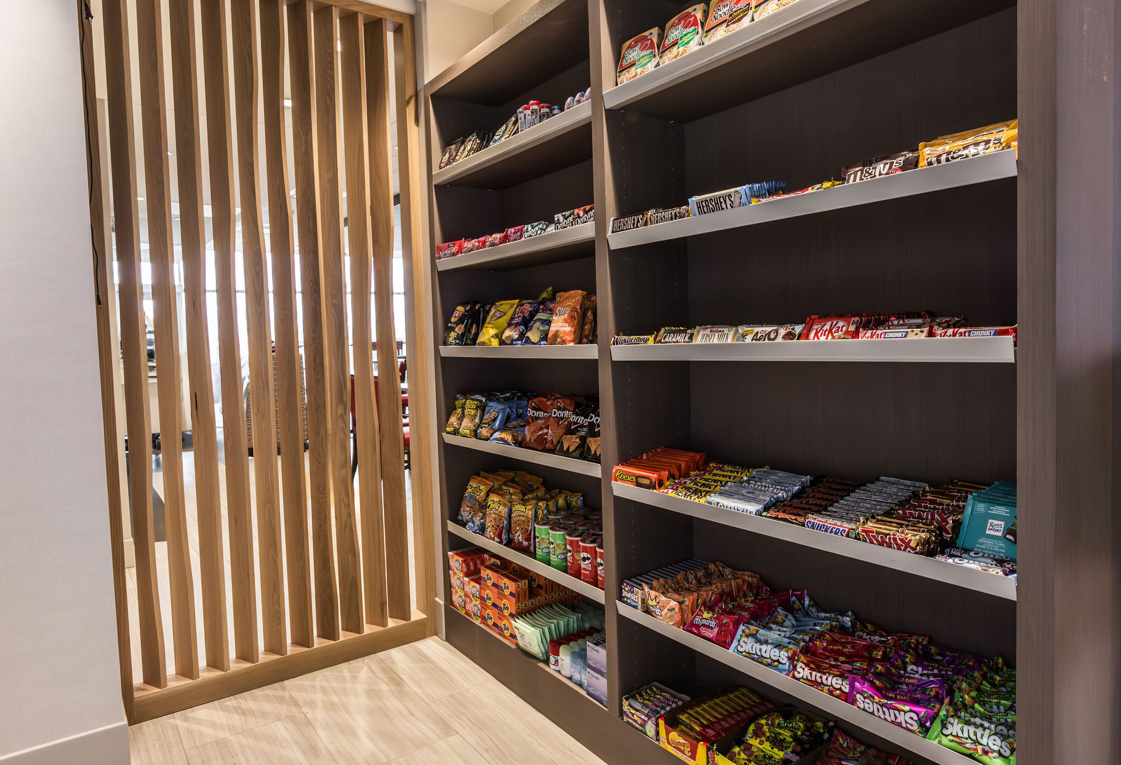 A candy aisle in a store with various brands and types of candies displayed on shelves.