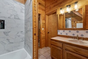 Enjoy a spacious bathroom with a large bathtub, double sink, and ample mirror space.