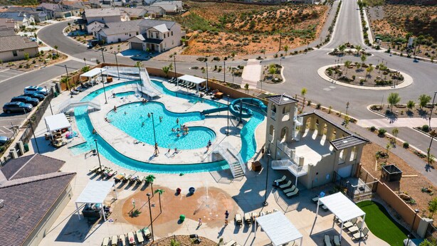 An aerial view of a resort with a large swimming pool, a water slide, and a parking area. - Waterpark Retreat w/ Lazy River, Pickleball Courts (Washington)