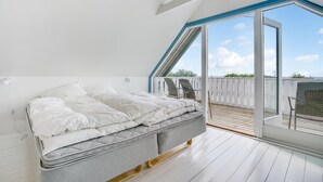 A bedroom with a bed, a window, and a view of the outside. - 3 bedroom lovely home in Slagelse (Slagelse)