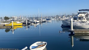 A marina with various boats docked, calm water, and a clear sky. - *Immaculate Villa! Waking Distance To All Local Favorites! Steps to the Beach!* (Newport Beach)
