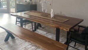 A spacious dining area with a long wooden table, benches, and modern chairs. - The Lake House on Amaroo Waterfront/Free WiFi/Includes Linen, SUP Boards/Kayaks  (Smiths Lake)