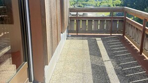 A balcony with a view of a mountainous landscape.