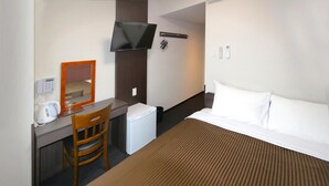 A hotel room with a bed, a desk with a chair, a television, and a small refrigerator. - ARIGATO STAY SUZUKA (Suzuka)