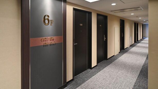 A hotel corridor with doors numbered 6F, 6G, and 6H, and a carpeted floor. - ARIGATO STAY SUZUKA (Suzuka)
