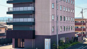 A multi-story building with a sign reading "ARIGATO STAY". - ARIGATO STAY SUZUKA (Suzuka)