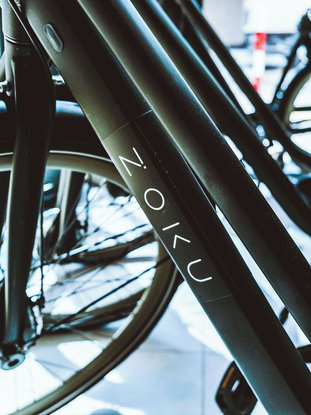 A close-up of a bicycle frame with the inscription 'NOKU'.