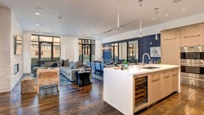 A modern kitchen with a central island, stainless steel appliances, and a dining area with a view. - Abode at Parkite #24, hot tub, balcony overlooking Main Street, gym, luxury condo (Park City)