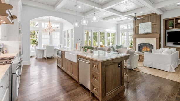 A spacious kitchen with a large island, wooden cabinets, and a fireplace. - Luxury Home w/ Private Heated Pool in Seagrove! (Santa Rosa Beach)