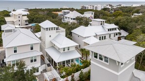A coastal residential area with multiple white houses, some with balconies, and a view of the ocean. - Luxury Home w/ Private Heated Pool in Seagrove! (Santa Rosa Beach)