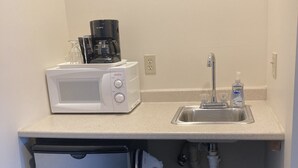 A compact kitchenette with a microwave, coffee maker, sink, and refrigerator. - Hotel Pratt in the heart of Cooperstown, New York **Baseball Central** (Cooperstown)
