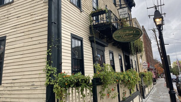 A building with a sign for 'Sherman's Tavern' and a 'Hotel Pratt' sign above it. - Hotel Pratt in the heart of Cooperstown, New York **Baseball Central** (Cooperstown)