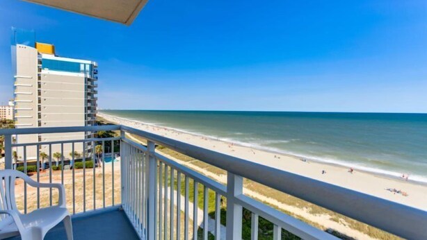 A balcony with a view of a beach and ocean. - Atlantica Resort 751 (Myrtle Beach)