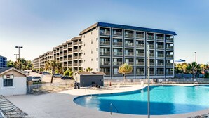 A modern hotel with multiple floors, a swimming pool, and a parking area. - Myrtle Beach Resort  (Myrtle Beach)