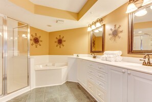A modern bathroom with a walk-in shower, a freestanding bathtub, and a vanity with a large mirror. - Ocean Bay Club 1701 Pent House Escape! (North Myrtle Beach)