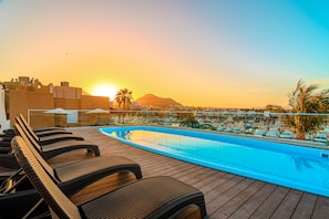 Relax by the pool with a stunning view of the marina and surrounding mountains.