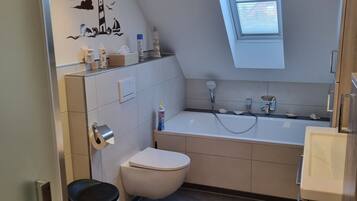 Bathtub, hair dryer, towels, soap