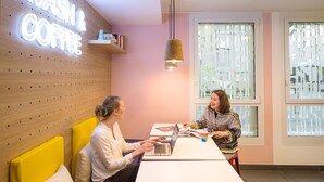A modern interior with a neon sign reading "WASH & COFFEE", a wooden wall with a pegboard, a hanging light fixture, and a window with frosted glass. - Hostel HOSHO Paris Sud Porte d'Italie (Le Kremlin-Bicetre)