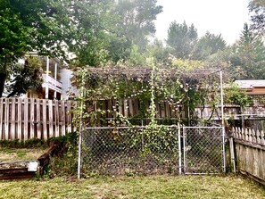 Enjoy an outdoor space with a wooden deck and a house in the background.