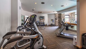 A gym with treadmills, elliptical machines, and free weights. - Ski-In/Out Condo | Lone Peak Views & Community Pool/Hot Tub (Big Sky)