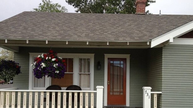 A house with a porch, a front door, and a mailbox. - Papa Bear Cottage (Downtown Cody) (Cody)