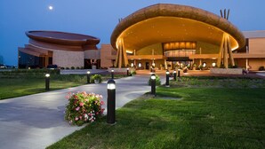 A modern building with a unique curved roof and a well-lit entrance. - Four-season lakefront charm in Northern Michigan (Harbor Springs)