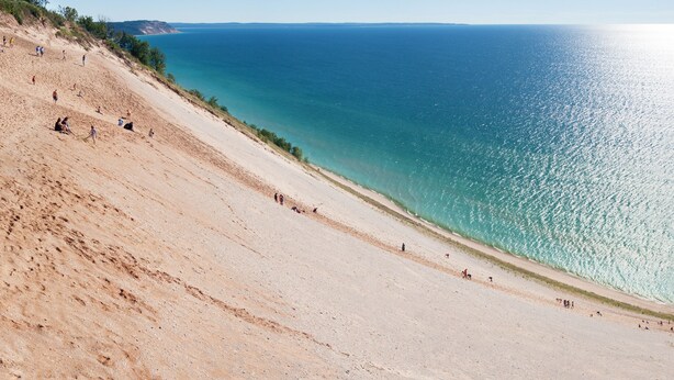 A beach with a sandy slope and a clear view of the ocean. - Four-season lakefront charm in Northern Michigan (Harbor Springs)