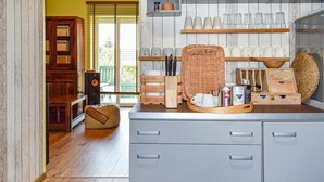 A kitchen with wooden cabinets, a countertop with a coffee maker, and a wicker basket.