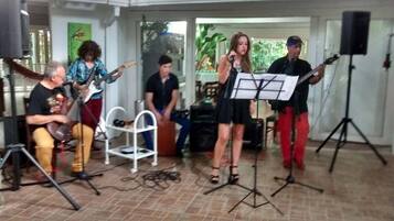 A group of people performing music with instruments and a music stand.