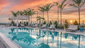 Una piscina al aire libre, tumbonas