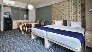 A hotel room with a bed, a desk, and a kitchenette. - MONday Apart Premium Akihabara (Tokyo)