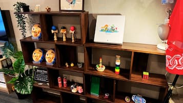 A wooden shelf with various items including a framed picture, a small plant, and decorative objects.