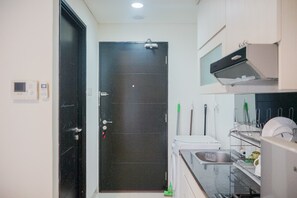 Fridge, stovetop, cookware/dishes/utensils - Minimalist Pool View Low Rise Studio @ Paramount Skyline Apartment (Gading Serpong)