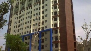 A tall residential building with multiple floors and balconies. - Comfy and Minimalist 1BR Apartment at Atria Residence (Gading Serpong)