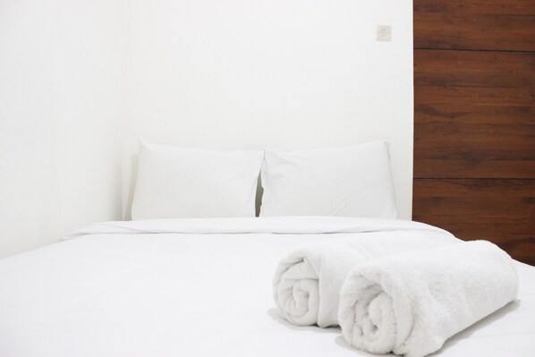 Restful retreat with a neatly made bed and plush linens.